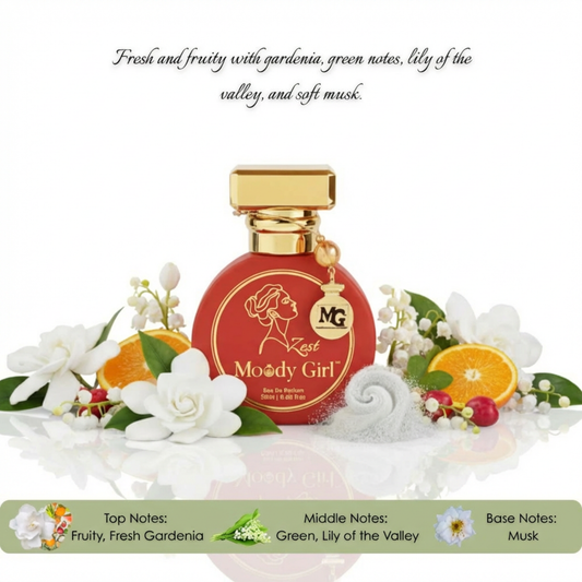 Moody Girl perfume bottle surrounded by flowers and fruits on a white background