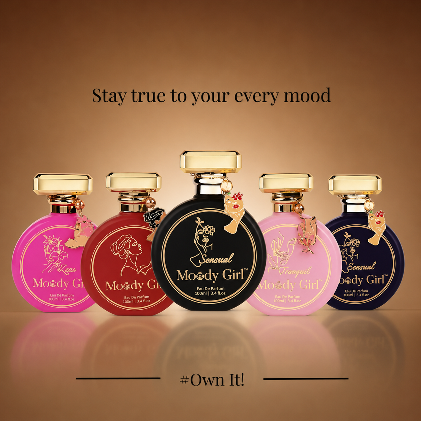 Five round perfume bottles labeled 'Sensual Moody Girl' in pink, red, black, light pink, and dark blue, arranged on a reflective brown gradient background with the text 'Stay true to your every mood' and '#Own It!'.