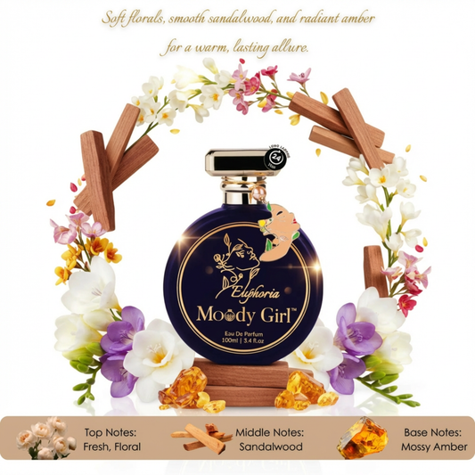 Perfume bottle labeled 'Euphoria Moody Girl' surrounded by flowers and wood elements on a white background.