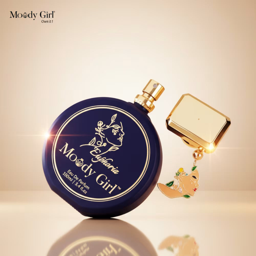Perfume bottle with gold cap and decorative tag on a beige background, featuring the brand 'Moody Girl'.