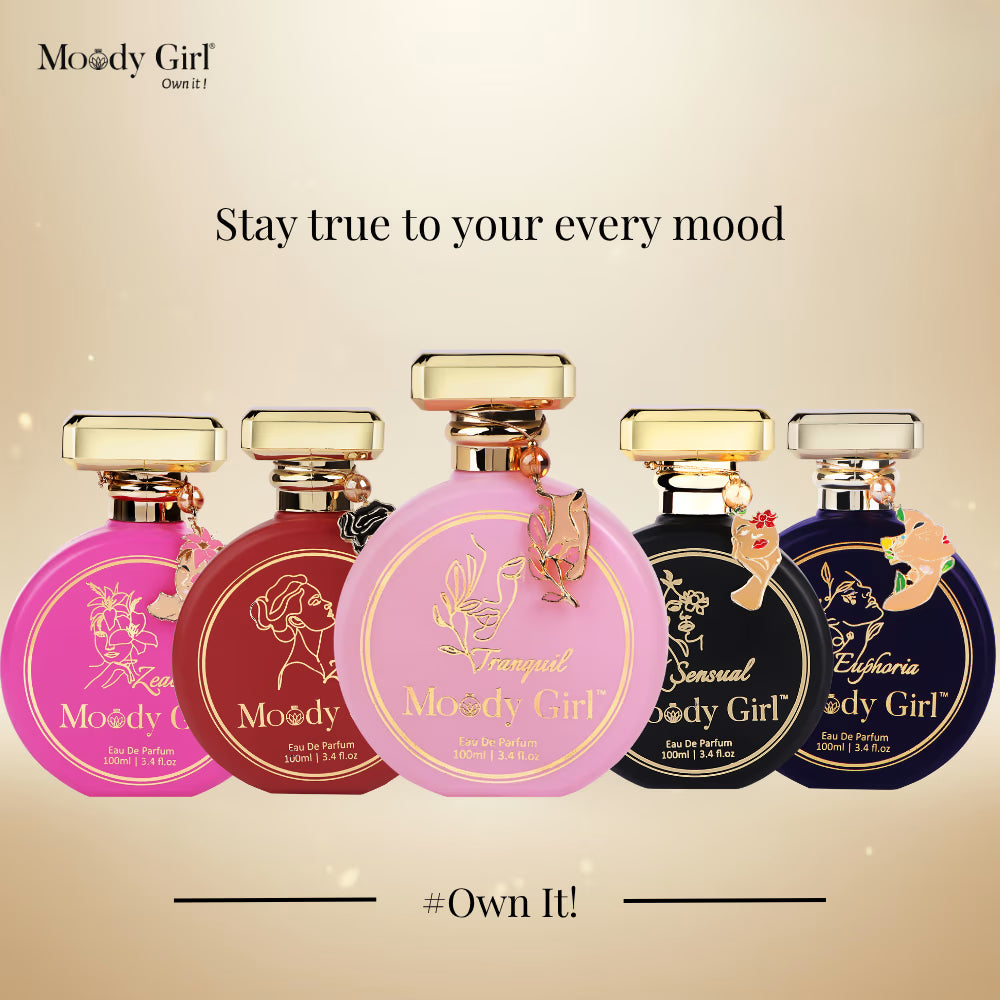 Five Moody Girl perfume bottles on a beige background with text 'Stay true to your every mood' and '#Own It!'.