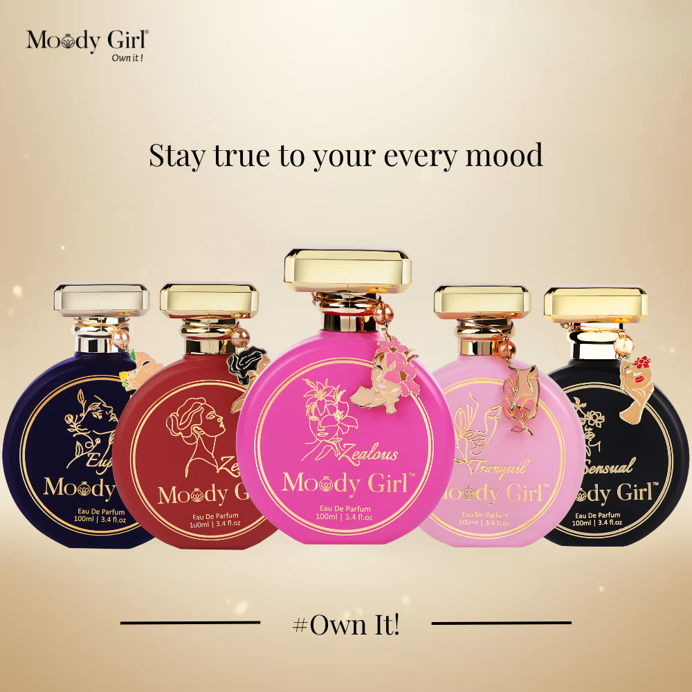 Five bottles of 'Moody Girl' perfume with colorful labels on a beige background.