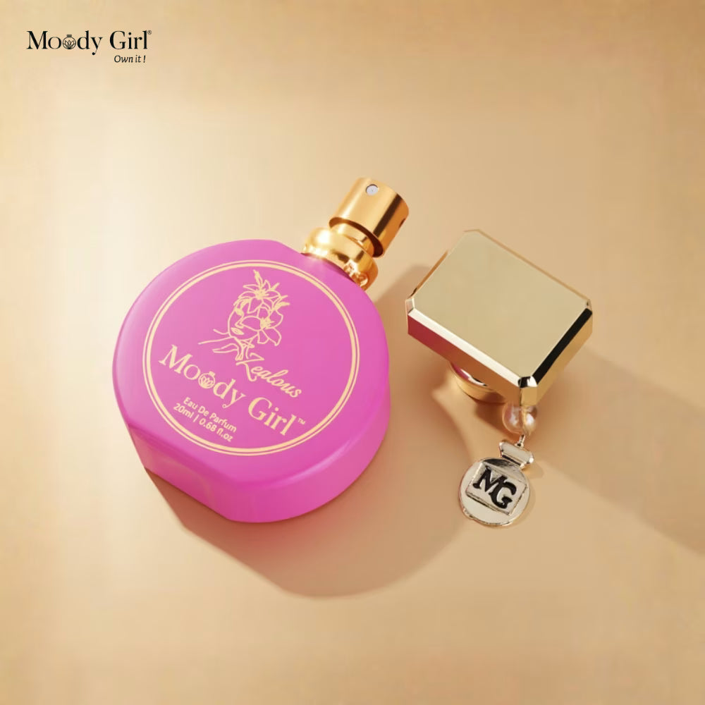 Pink and gold perfume bottle with 'Moody Girl' branding on a beige background
