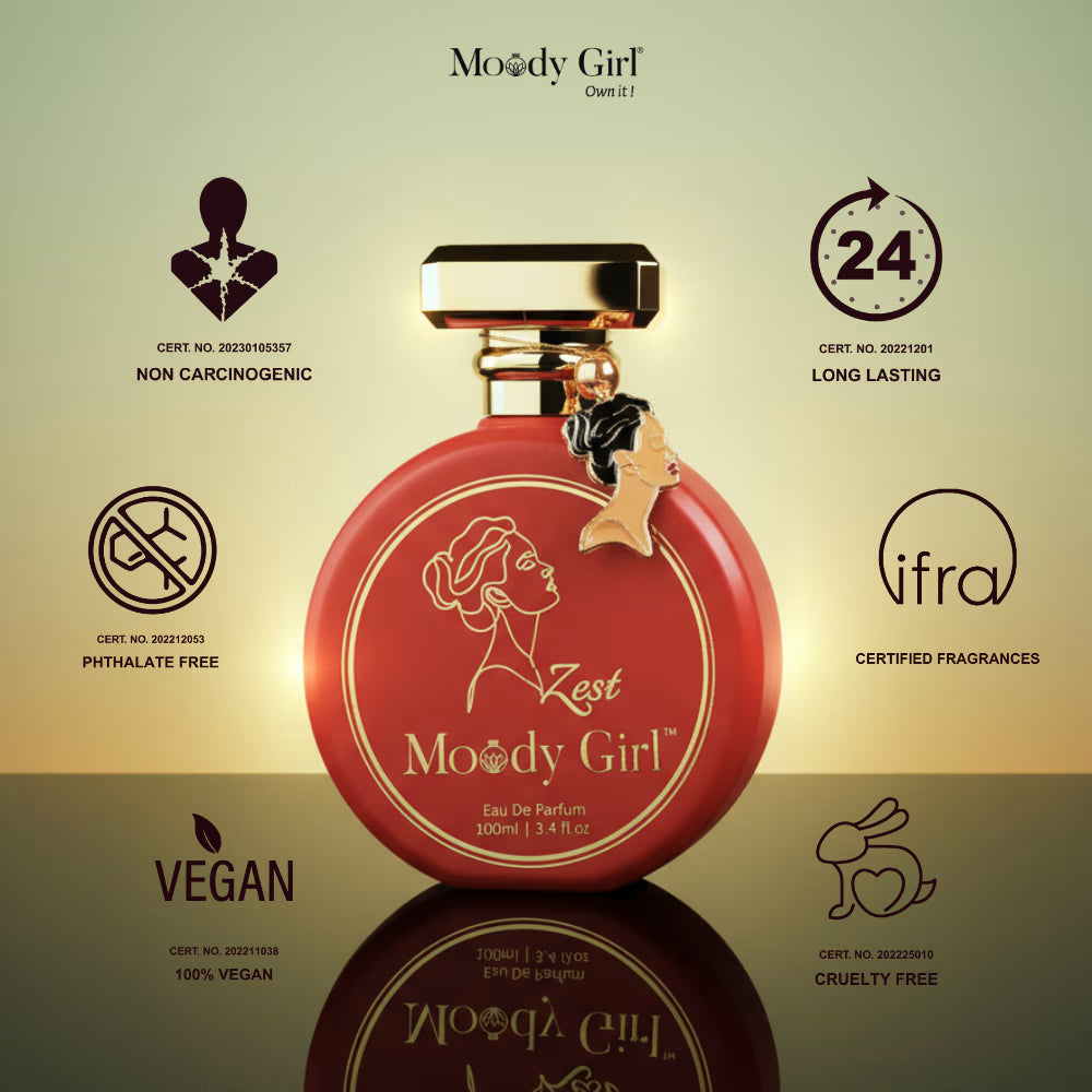 Red perfume bottle with gold cap on a reflective surface, featuring 'Moody Girl' branding and certification logos.