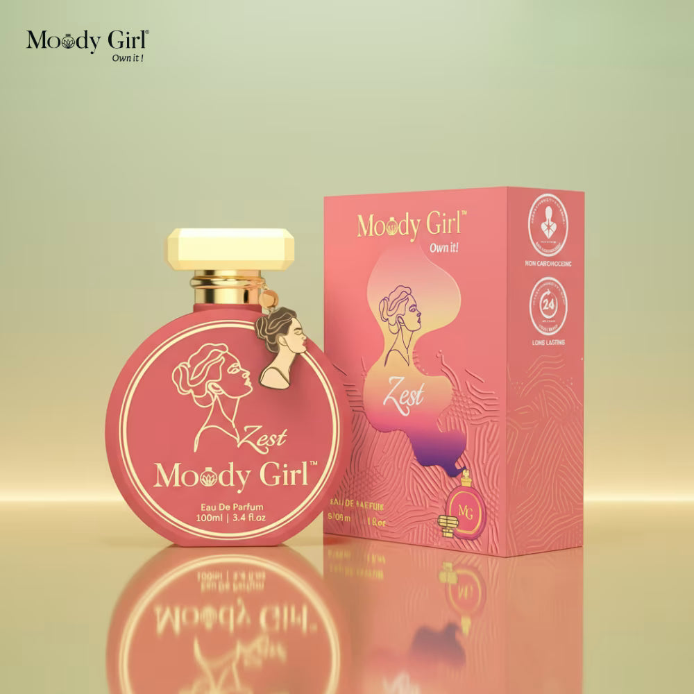 Moody Girl Zest perfume bottle and packaging on a reflective surface with a gradient background
