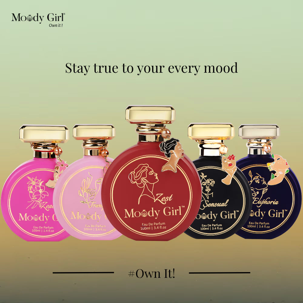 Five Moody Girl perfume bottles with different colored labels on a light green background.