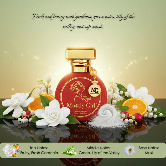 Moody Girl perfume bottle with floral and fruit elements on a reflective surface.