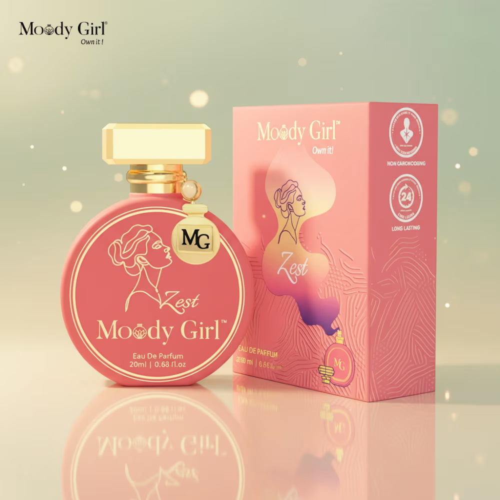 Pink 'Moody Girl' perfume bottle and packaging on a reflective surface with a soft, blurred background.
