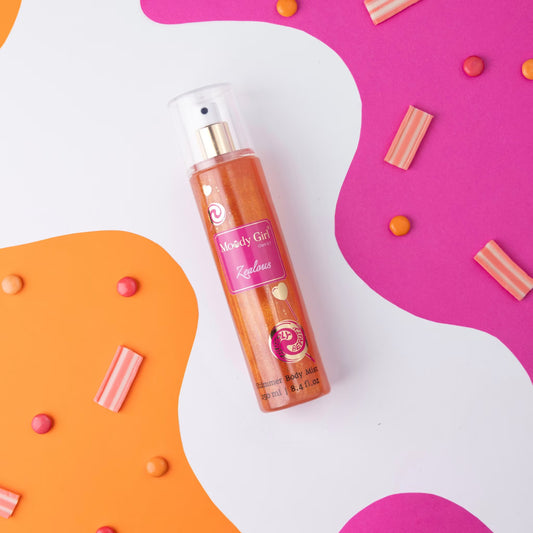 Moody Girl Zealous shimmer body mist spray bottle with pink label on a colorful abstract background