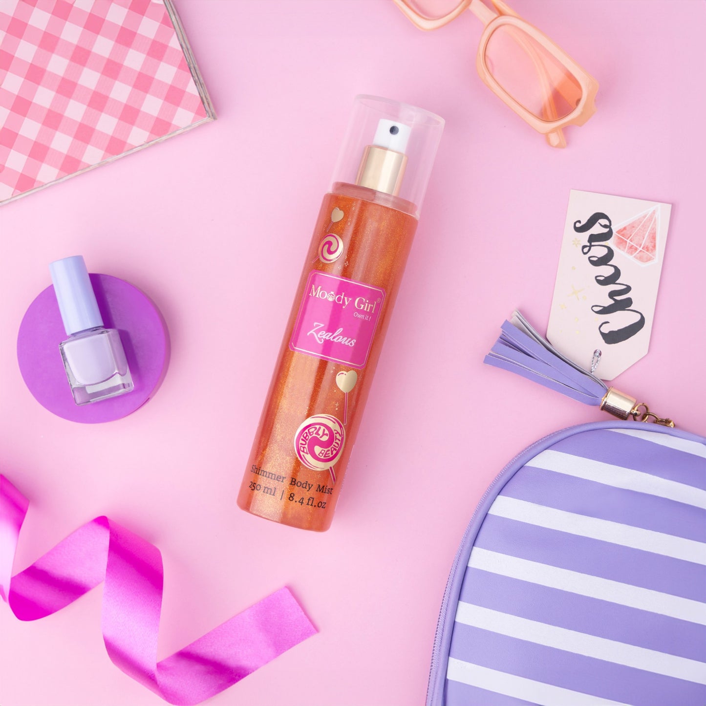 Makeup products including a bottle of body mist, nail polish, and a striped pouch on a pink background.