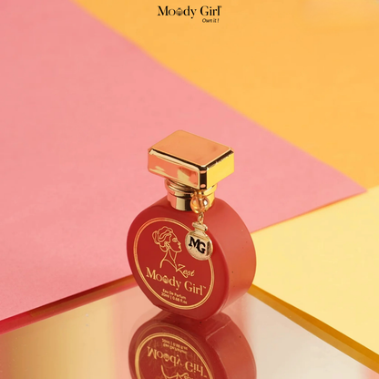 Red perfume bottle with gold cap on a pink and yellow geometric background, featuring the 'Moody Girl' brand.