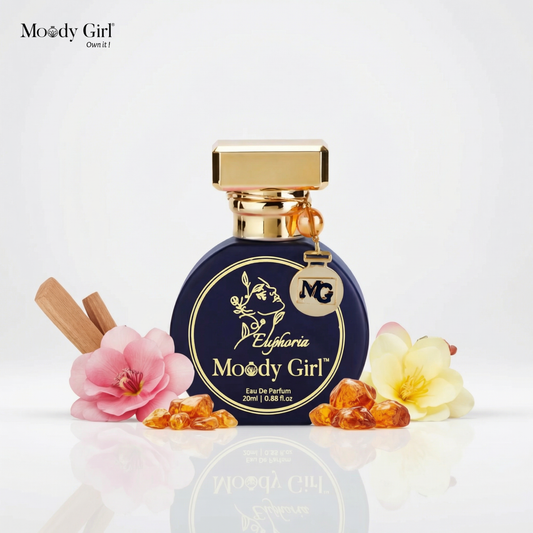 Moody Girl Euphoria perfume bottle with flowers and cinnamon sticks on a white background