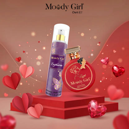 Two perfume bottles by 'Moody Girl' on a red platform with heart-shaped decorations and a pink gradient background.