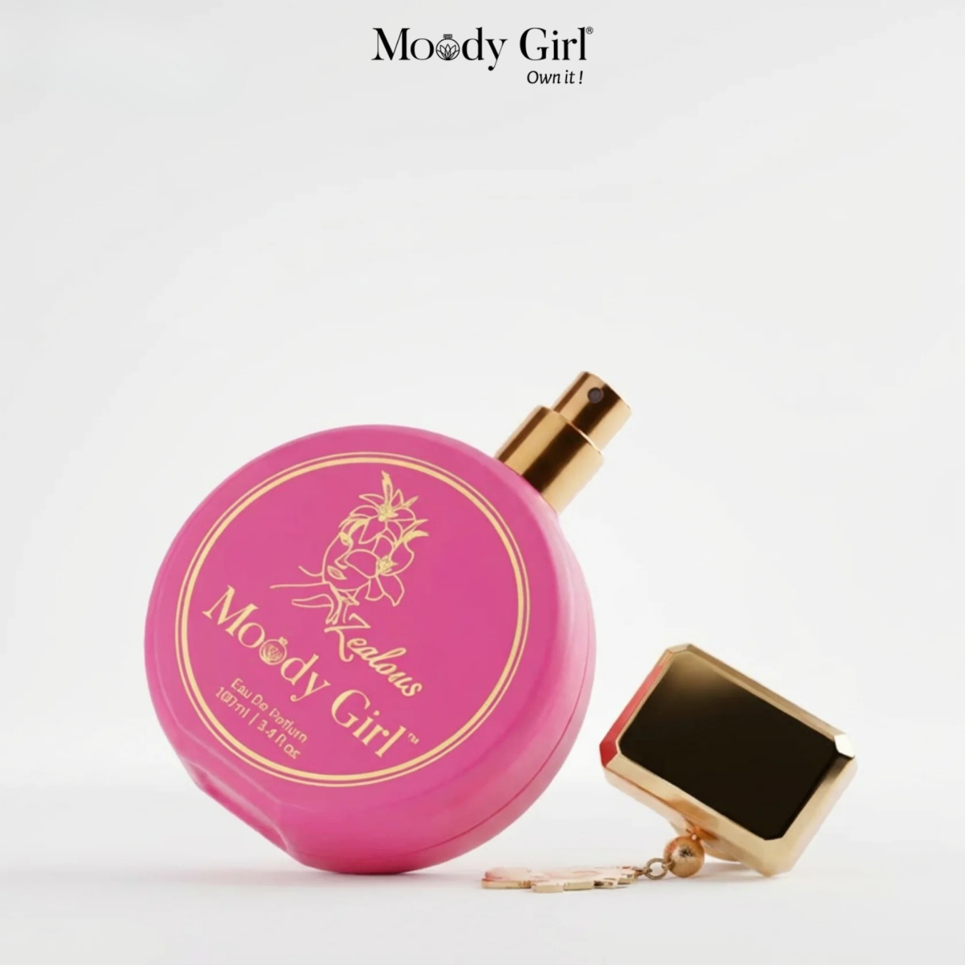 Pink perfume bottle with gold cap and 'Moody Girl' branding on a white background