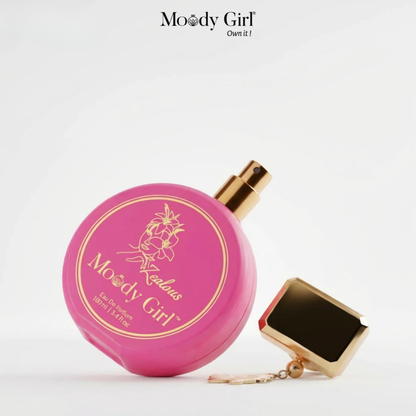 Pink perfume bottle with gold cap and 'Moody Girl' branding on a white background