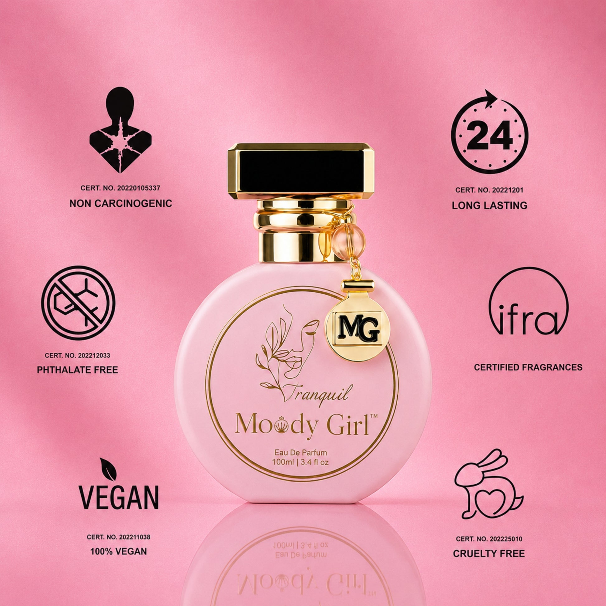 A pink round perfume bottle labeled 'François Moody Girl' with a gold cap and hanging MG charm, centered on a pink background with certification icons and text around it.