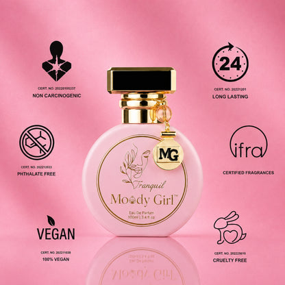 A pink round perfume bottle labeled 'François Moody Girl' with a gold cap and hanging MG charm, centered on a pink background with certification icons and text around it.