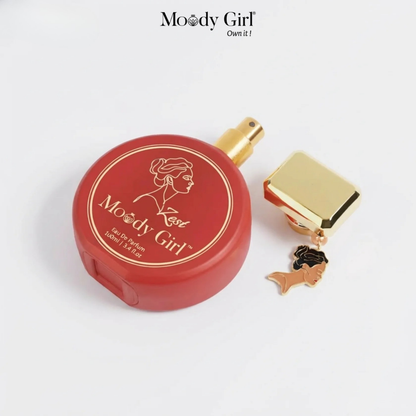 Red perfume bottle with gold cap and 'Moody Girl' branding on a white background