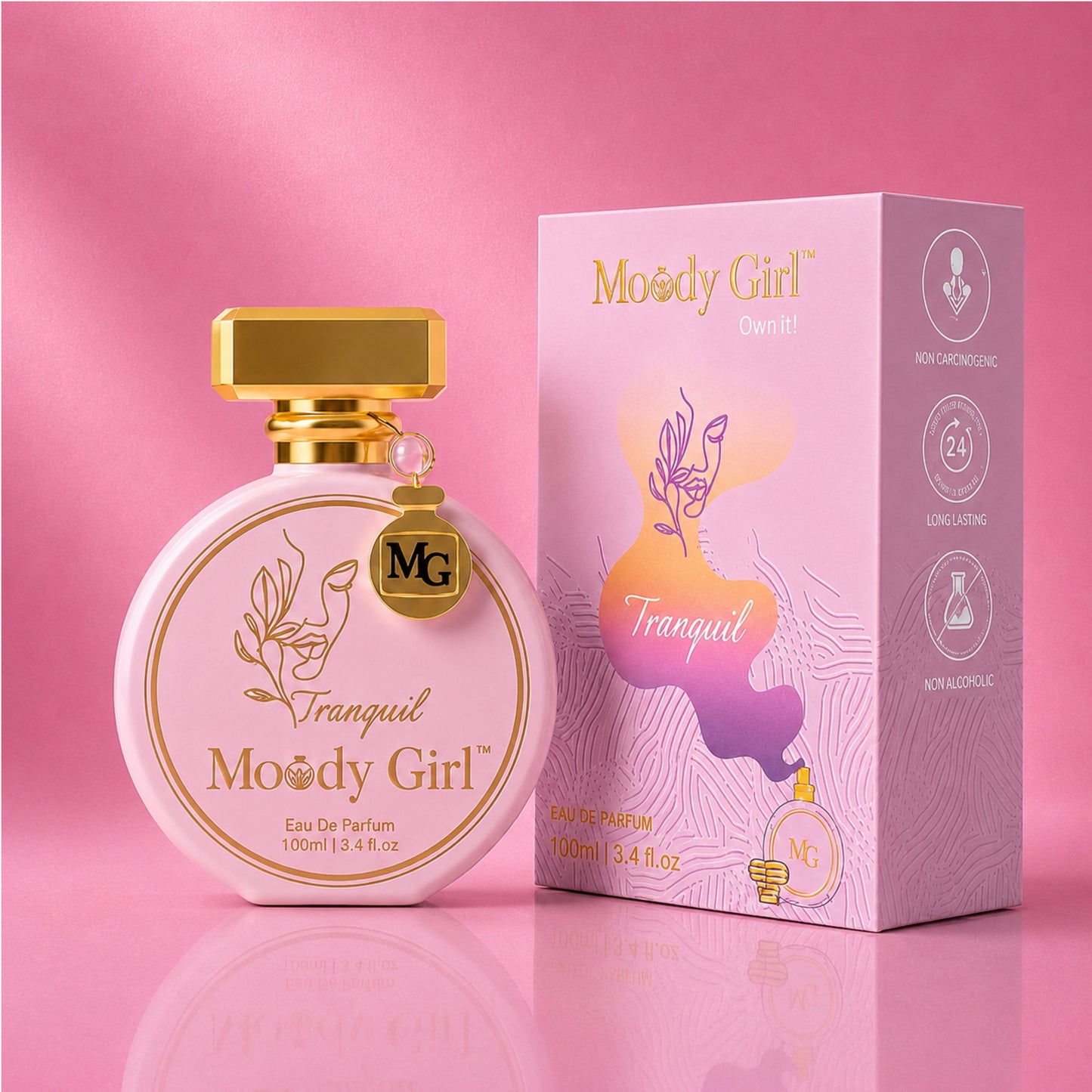A pink and gold bottle of Moody Girl Tranquil Eau De Parfum next to its matching pink and gold packaging box, set against a solid pink background.