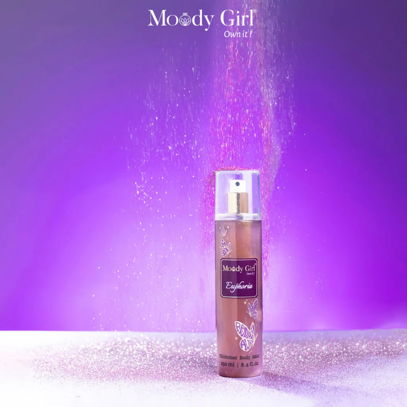 Moody Girl Euphoria body mist with glittery effect on a purple background