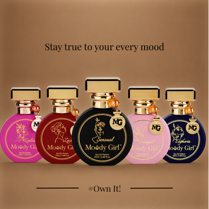 Five MG perfume bottles in different colors (pink, burgundy, black, light pink, and navy blue) lined up on a brown gradient background with the text 'Stay true to your every mood' and '#Own It!'.