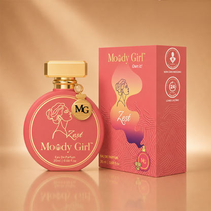 Moody Girl Zest Eau De Parfum 20ml bottle and its matching retail box, both in a vibrant pink color with gold accents, set against a warm beige background.