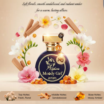 Perfume bottle labeled 'Moody Girl' surrounded by flowers and amber on a beige background
