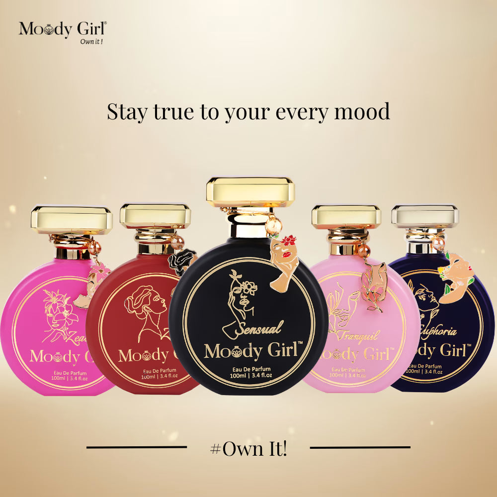 Five Moody Girl perfume bottles on a beige background with text 'Stay true to your every mood' and '#Own It!'.