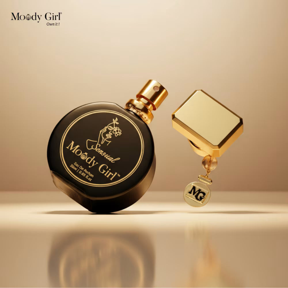 Black and gold perfume bottle with 'Moody Girl' branding on a beige background