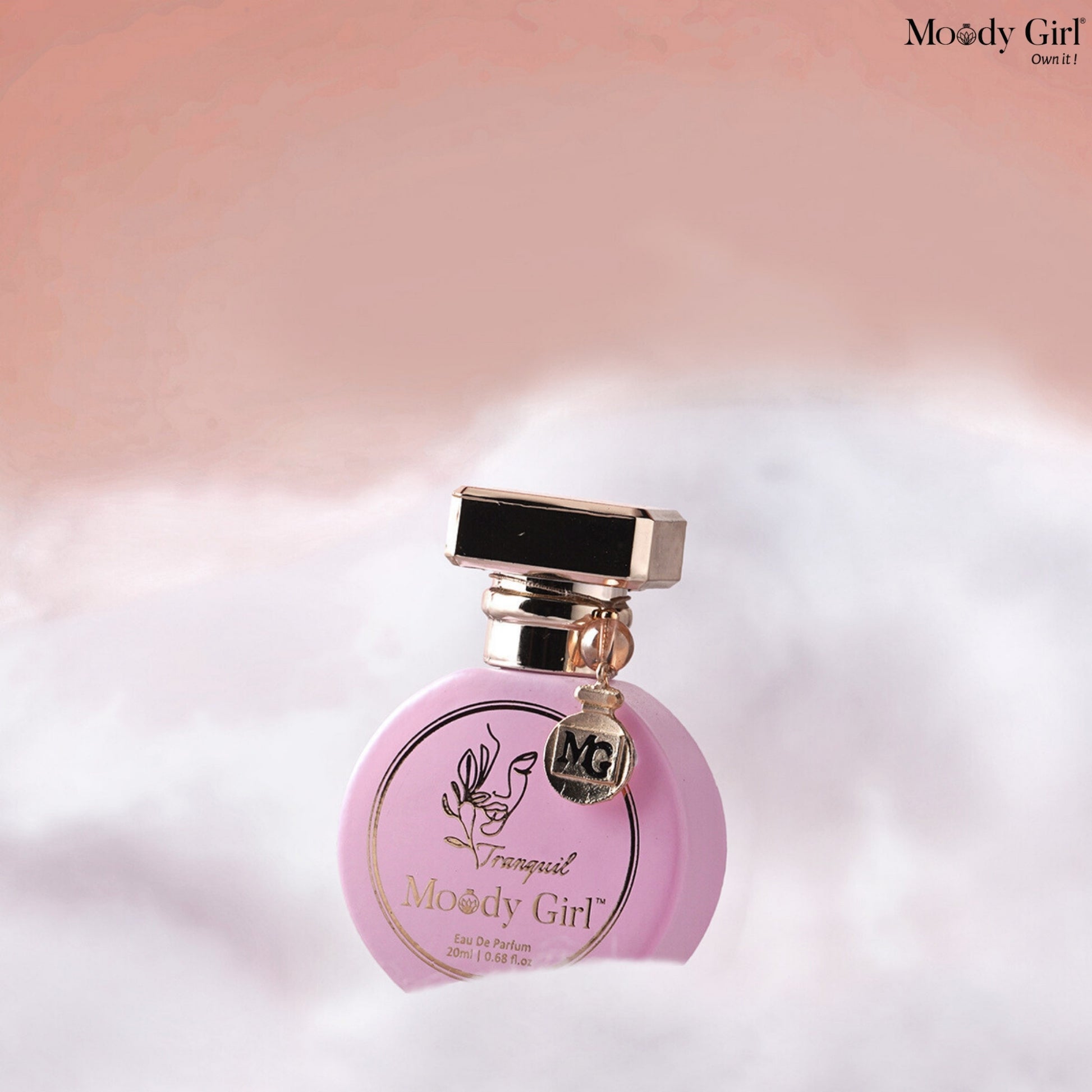 Pink perfume bottle with gold accents on a soft, blurred background