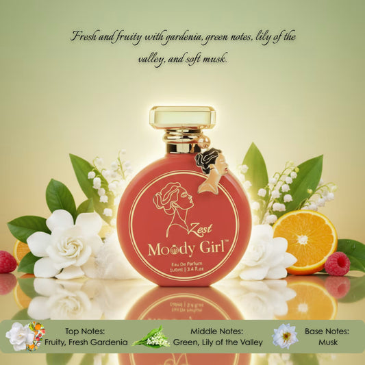 Perfume bottle labeled 'Zest Moody Girl' with floral and fruit elements on a reflective surface.