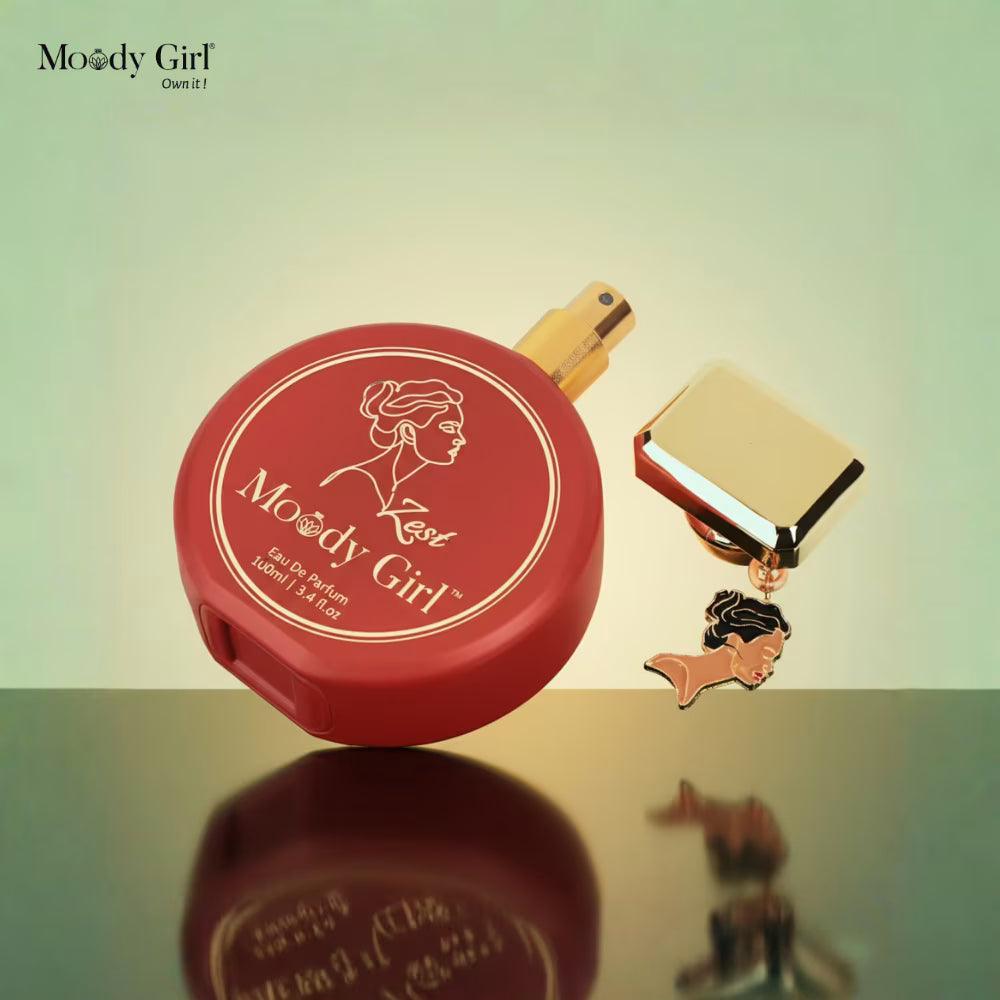 Red compact mirror with gold accents and 'Moody Girl' branding on a reflective surface.