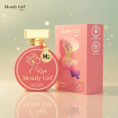 Pink 'Moody Girl' perfume bottle and packaging on a reflective surface with a soft, blurred background.