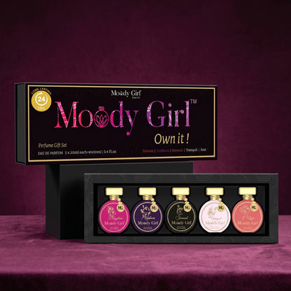 Moody Girl perfume gift set with six small bottles on a purple background