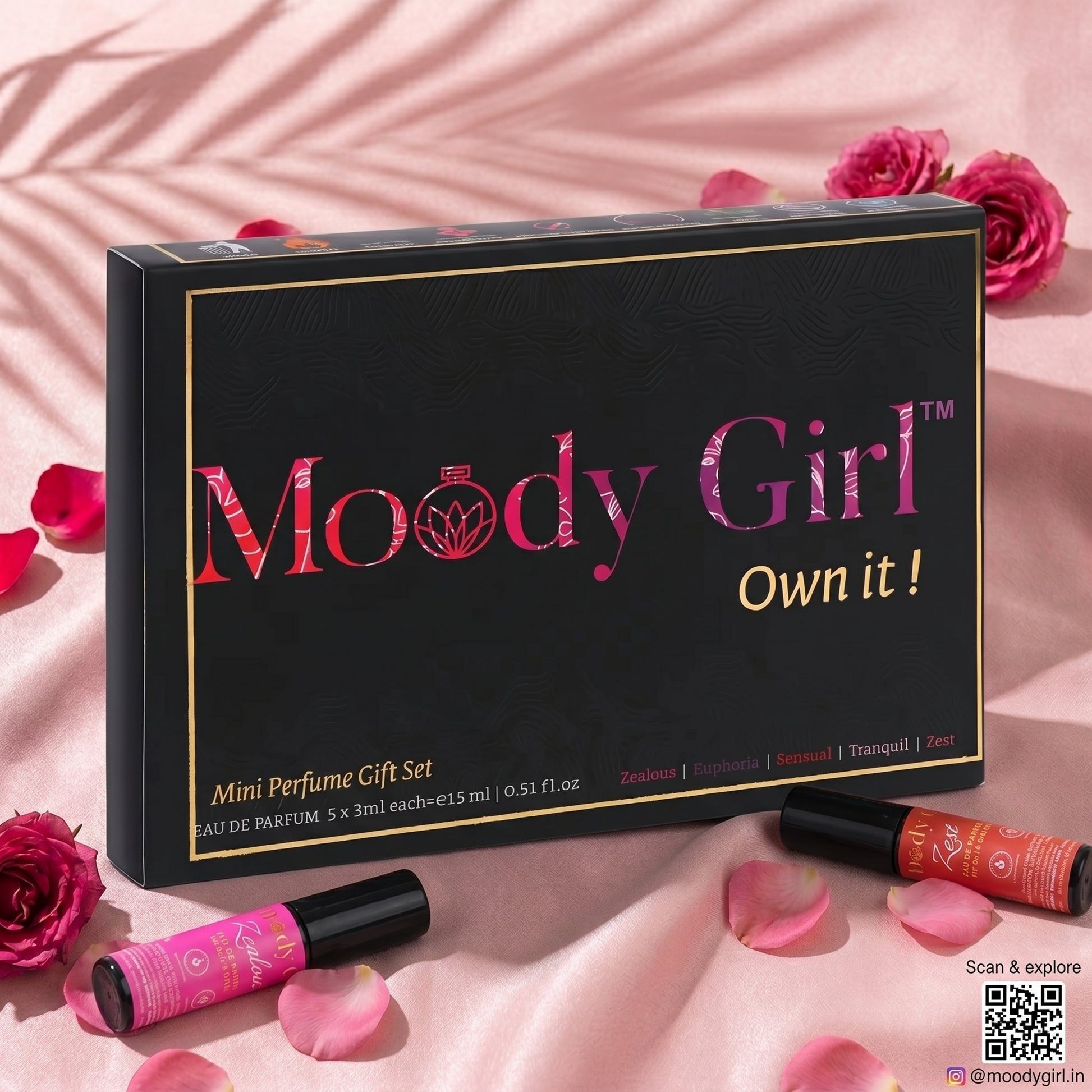 Moody Girl mini perfume gift set on a pink background with roses and rose petals.