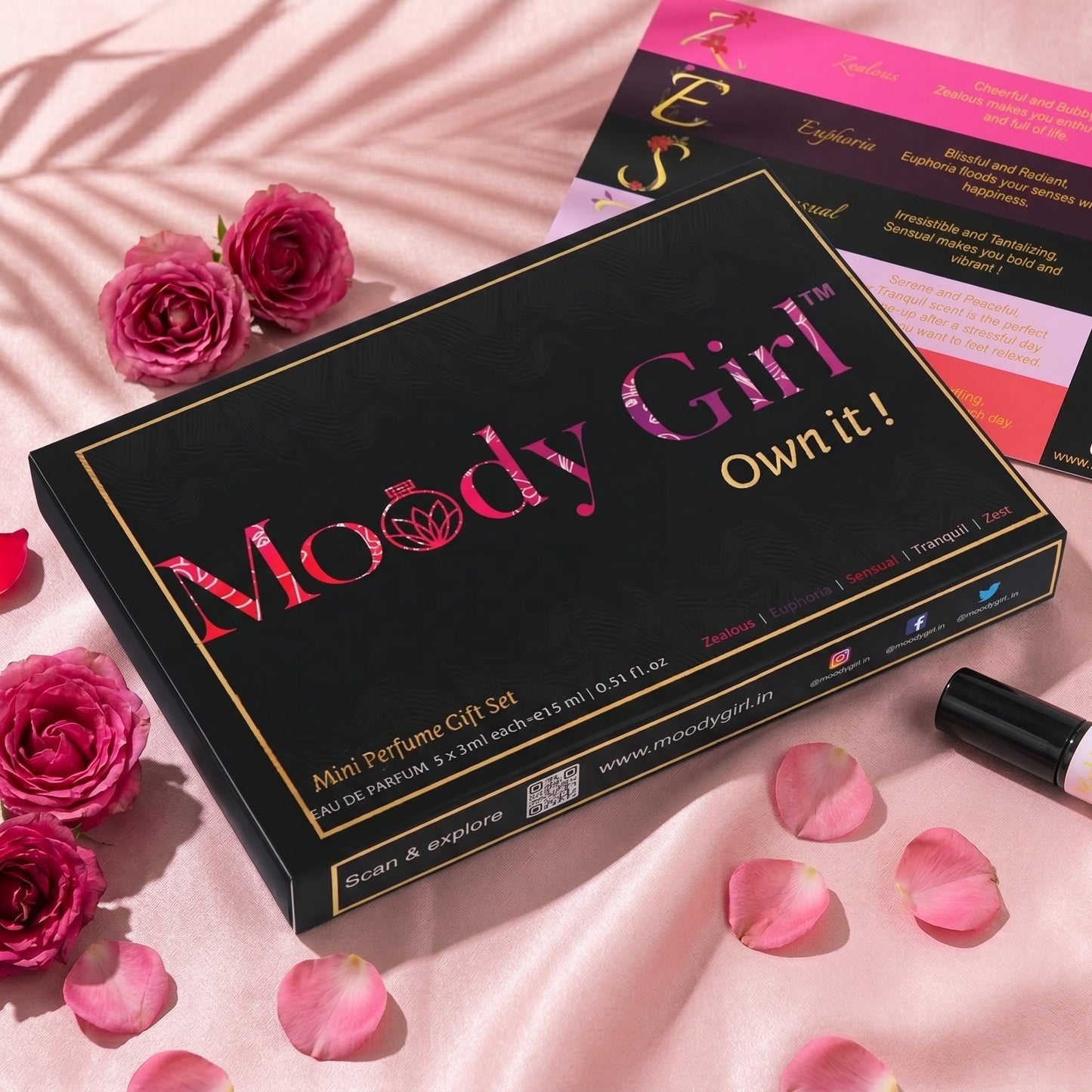 Moody Girl mini perfume gift set with pink roses and petals on a pink background