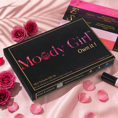 Moody Girl mini perfume gift set with pink roses and petals on a pink background