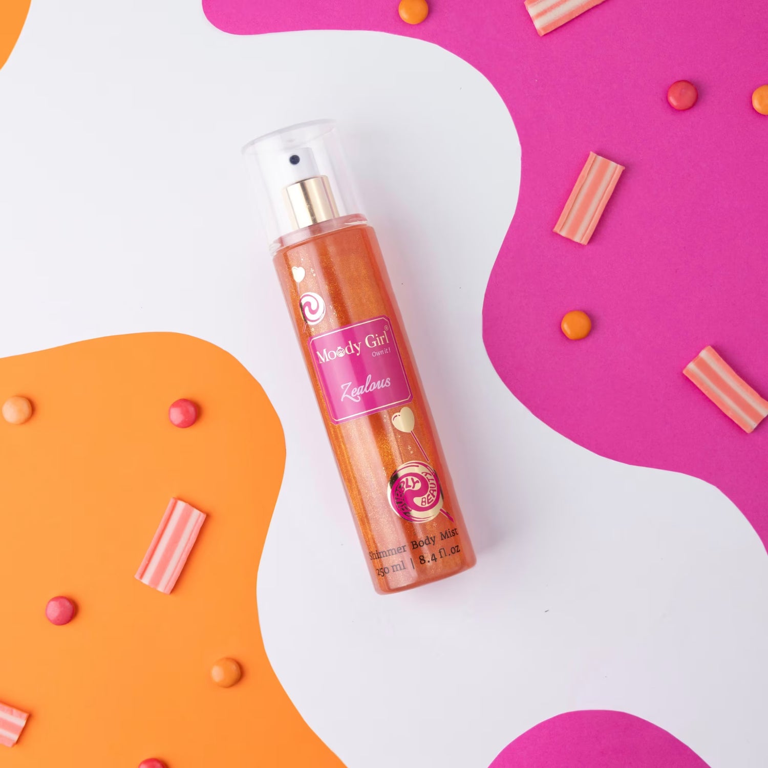 Moody Girl Zealous shimmer body mist spray bottle with pink label on a colorful abstract background