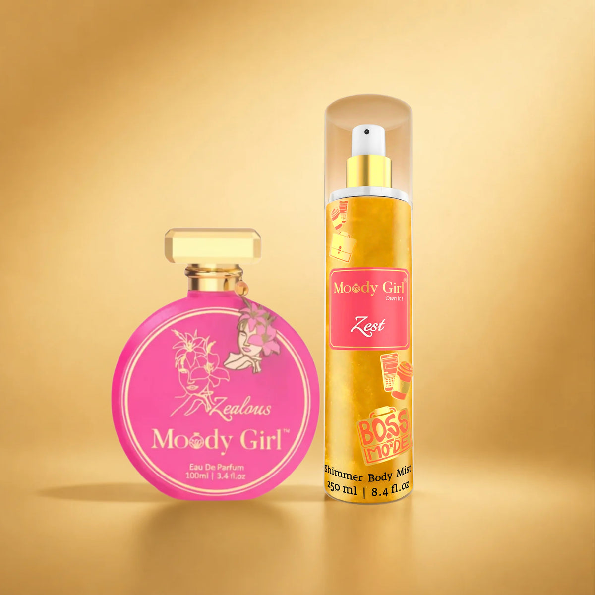 Two fragrance products on a warm gold gradient background: a round pink perfume bottle labeled 'Majestic Moody Girl' and a tall cylindrical body mist canister with a clear cap, gold spray top, and pink label reading 'Moody Girl Zest'.